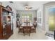 Bright dining room features a wood table with six chairs, and built-in hutch at 4719 Avila Lakes Dr, Wimauma, FL 33598