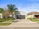 Two-car garage and attractive landscaping at 4719 Avila Lakes Dr, Wimauma, FL 33598