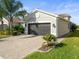 Dark gray garage door and manicured lawn at 4719 Avila Lakes Dr, Wimauma, FL 33598
