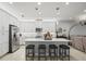 Modern kitchen with white cabinets, large island, and stainless steel appliances at 4719 Avila Lakes Dr, Wimauma, FL 33598