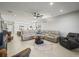 Open floor plan with large sectional and view into kitchen at 4719 Avila Lakes Dr, Wimauma, FL 33598