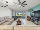 Relaxing living room boasts a view of the lake from sliding doors at 4719 Avila Lakes Dr, Wimauma, FL 33598