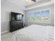 Bright bedroom with king-size bed and large window at 4719 Avila Lakes Dr, Wimauma, FL 33598