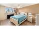 Bright bedroom with a queen bed, wood floors, and window at 4880 Locust Ne St # 227, St Petersburg, FL 33703