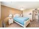 Light and airy bedroom with a full bed, ceiling fan, and wood floors at 4880 Locust Ne St # 227, St Petersburg, FL 33703