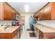 Well-equipped kitchen with wood cabinets and stainless steel appliances at 4880 Locust Ne St # 227, St Petersburg, FL 33703