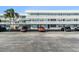 Exterior view of condo building with assigned parking spaces at 4880 Locust Ne St # 227, St Petersburg, FL 33703