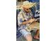 Personal carving wood while wearing a straw hat and floral shirt at 4902 31St S Ave # 109, Gulfport, FL 33707