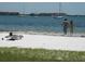 People relaxing on a beach with calm water at 4902 31St S Ave # 109, Gulfport, FL 33707