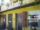 Yellow building with a cafe sign and outdoor seating at 4902 31St S Ave # 109, Gulfport, FL 33707