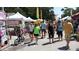 People walking at an outdoor market with various tents at 4902 31St S Ave # 109, Gulfport, FL 33707