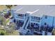 Aerial view of a light blue two-story building with multiple balconies, patios, and kayaks at 5176 Se Salmon Se Dr # D, St Petersburg, FL 33705