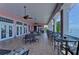 Covered balcony with multiple tables and chairs, waterfront view at 5176 Se Salmon Se Dr # D, St Petersburg, FL 33705