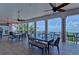 Covered balcony overlooking the water; tables, chairs, and ceiling fans at 5176 Se Salmon Se Dr # D, St Petersburg, FL 33705