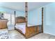 Main bedroom with a wooden four poster bed and window shutters at 5176 Se Salmon Se Dr # D, St Petersburg, FL 33705