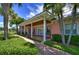 Community clubhouse with inviting porch and landscaping at 5176 Se Salmon Se Dr # D, St Petersburg, FL 33705