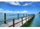 Long wooden dock stretching into the water at 5176 Se Salmon Se Dr # D, St Petersburg, FL 33705