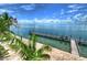 Long wooden dock with chairs overlooking the water at 5176 Se Salmon Se Dr # D, St Petersburg, FL 33705