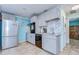 Modern kitchen with gray cabinets, marble backsplash, and stainless steel appliances at 5176 Se Salmon Se Dr # D, St Petersburg, FL 33705