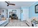 Living room with TV, comfy seating, and access to balcony at 5176 Se Salmon Se Dr # D, St Petersburg, FL 33705