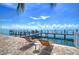 Waterfront patio with lounge chairs and a private dock at 5176 Se Salmon Se Dr # D, St Petersburg, FL 33705