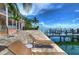 Pool deck with lounge chairs and access to the waterfront at 5176 Se Salmon Se Dr # D, St Petersburg, FL 33705