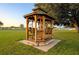 Relaxing gazebo with wooden swing in a lush green lawn at 5312 Betty St, Zephyrhills, FL 33542