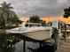 Cream and gray powerboat on a boat lift at sunset at 5321 Dover Ne St, St Petersburg, FL 33703