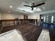 Large living area with hardwood floors and a ceiling fan; currently under renovation at 5321 Dover Ne St, St Petersburg, FL 33703