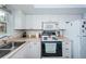 White kitchen with stainless steel appliances and view of the sink at 5880 38Th N Ave # 108, St Petersburg, FL 33710