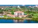 Aerial view of condo building near water, golf course, and bridge at 6104 Palma Del Mar S Blvd # 404, St Petersburg, FL 33715
