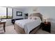 Spacious bedroom with a wooden bed frame and large window at 6104 Palma Del Mar S Blvd # 404, St Petersburg, FL 33715