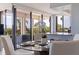 Condo dining area with glass table, off-white chairs, and balcony view at 6104 Palma Del Mar S Blvd # 404, St Petersburg, FL 33715