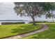 Curved walkway leading to a waterfront view, near a large tree at 6104 Palma Del Mar S Blvd # 404, St Petersburg, FL 33715