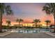 Community pool at sunset with palm trees and pergola at 6233 Golden Beach Dr, Apollo Beach, FL 33572