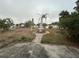 Large backyard with a fountain and mature landscaping at 6947 Bottle Brush Dr, Port Richey, FL 34668