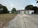 House exterior with driveway and yard at 6947 Bottle Brush Dr, Port Richey, FL 34668