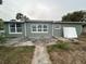 Rear view of house, showing patio and yard at 6947 Bottle Brush Dr, Port Richey, FL 34668
