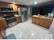 Spacious kitchen, featuring stainless steel appliances and granite countertops at 6947 Bottle Brush Dr, Port Richey, FL 34668