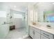 Bathroom with a large walk-in shower, double vanity, and modern fixtures at 920 N Osceola Ave # 702, Clearwater, FL 33755