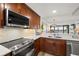 Modern kitchen with stainless steel appliances and island at 9525 Blind Pass Rd # 507, St Pete Beach, FL 33706