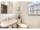 Small bathroom with a toilet and sink, and a window at 9649 Wilsky Blvd # 3, Tampa, FL 33615