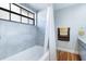Clean bathroom with a shower/tub combo and updated tile at 9649 Wilsky Blvd # 3, Tampa, FL 33615