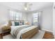 Light and airy bedroom with a queen bed and wood floors at 9649 Wilsky Blvd # 3, Tampa, FL 33615