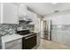 Modern kitchen with stainless steel appliances and white cabinets at 9649 Wilsky Blvd # 3, Tampa, FL 33615