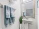 Well-lit powder room with a pedestal sink and decorative towels at 10601 Shady Falls Ct, Riverview, FL 33578