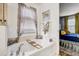 Bathroom with soaking tub, decorative tile, and window with privacy blinds at 10601 Shady Falls Ct, Riverview, FL 33578