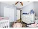 Cozy Bedroom featuring a crib, dresser, and gray walls at 10601 Shady Falls Ct, Riverview, FL 33578