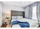 Bedroom featuring a gray headboard, light blue bedding, and a window at 10601 Shady Falls Ct, Riverview, FL 33578