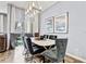 Bright dining room features an elegant table, chairs, lighting, and sliding glass door at 10601 Shady Falls Ct, Riverview, FL 33578
